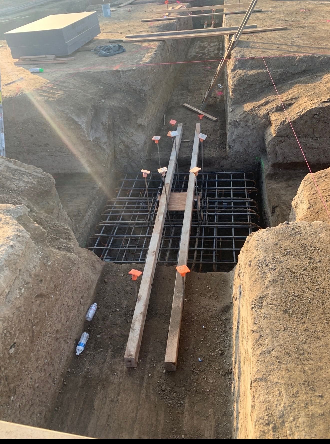 Reinforced footing in excavated trench